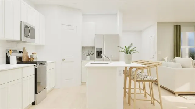 a kitchen with stainless steel appliances a sink a table and chairs in it