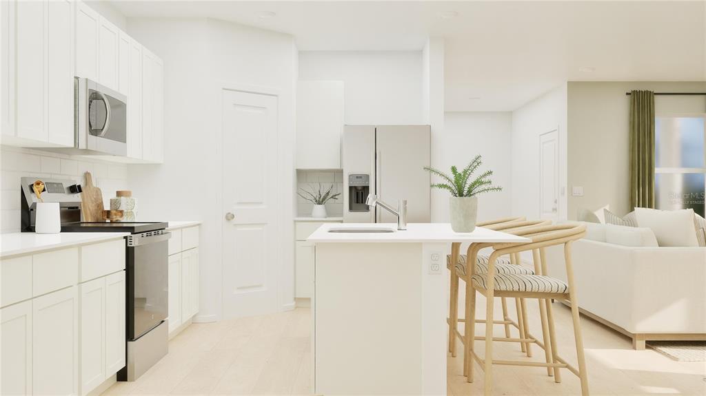5200 Clay Whaley Road St. Cloud, FL 34772 - Photo 3 of 27 a kitchen with stainless steel appliances a sink a table and chairs in it