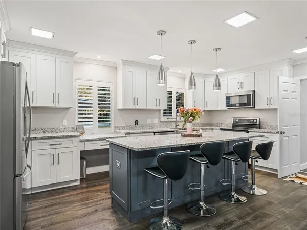 a kitchen with center island and stainless steel appliances