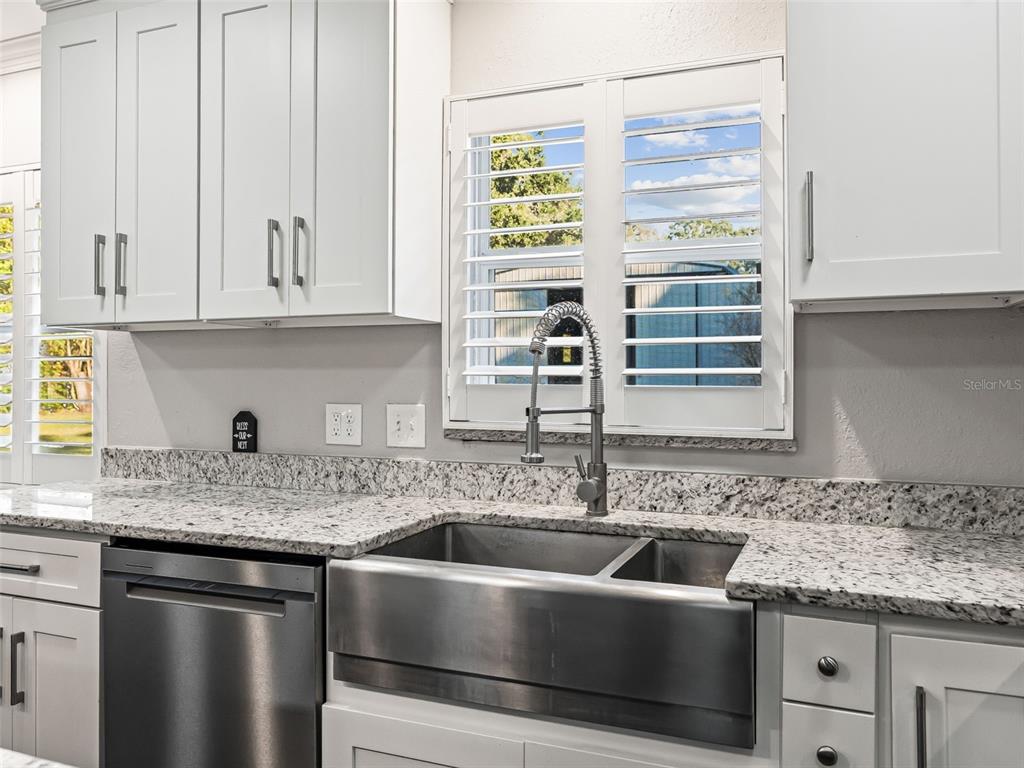 3505 Northeast 97th Street Road Anthony, FL 32617 - Photo 13 of 36 a kitchen with granite countertop a sink and a stove
