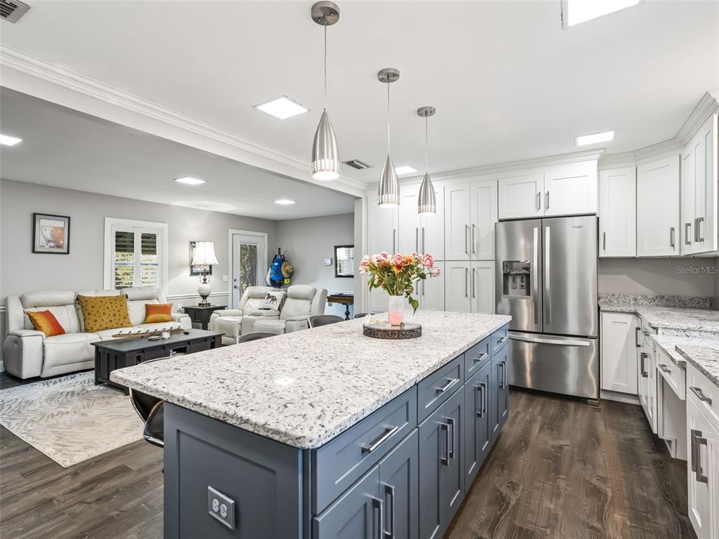 3505 Northeast 97th Street Road Anthony, FL 32617 - Photo 14 of 36 a kitchen with center island and stainless steel appliances