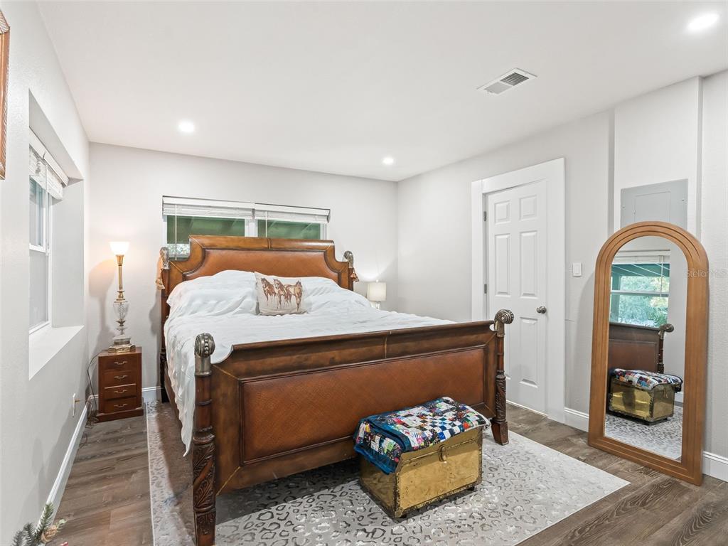 3505 Northeast 97th Street Road Anthony, FL 32617 - Photo 16 of 36 a bedroom with a bed and wooden floor