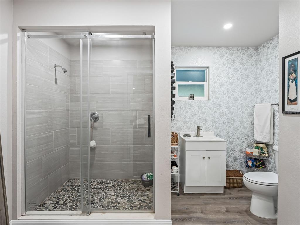3505 Northeast 97th Street Road Anthony, FL 32617 - Photo 18 of 36 a bathroom with a granite countertop toilet a sink and a mirror