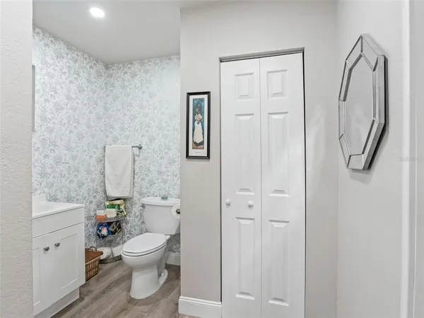 a bathroom with a granite countertop sink a toilet and a mirror