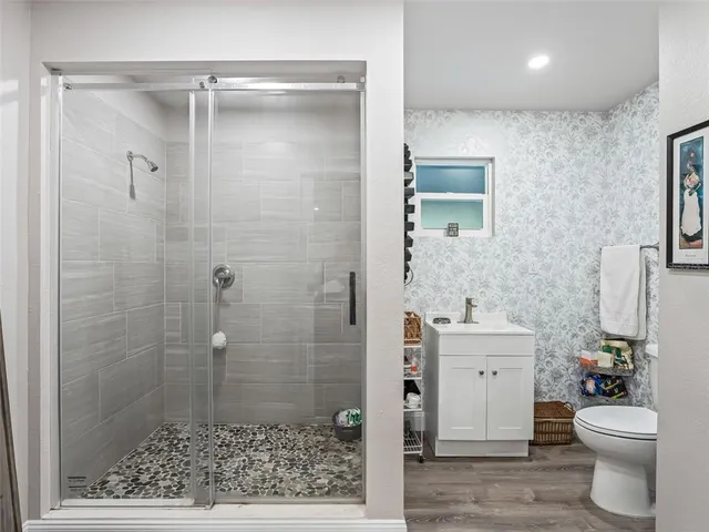 a white toilet sitting next to a bathroom sink