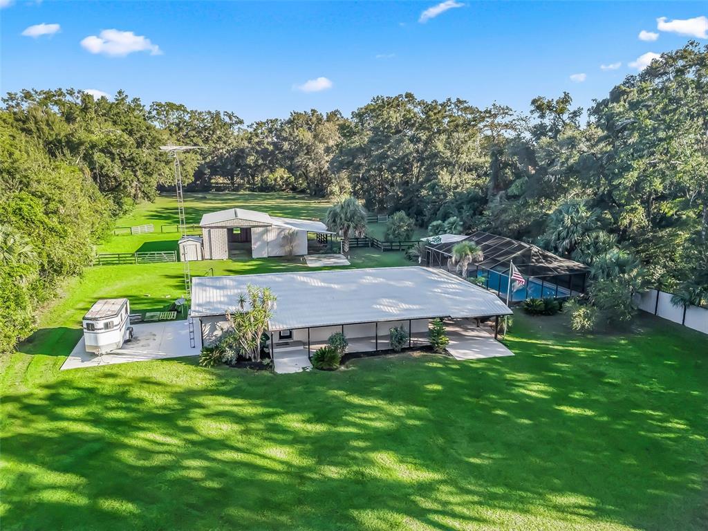 3505 Northeast 97th Street Road Anthony, FL 32617 - Photo 2 of 38 a view of a house with a yard table and chairs