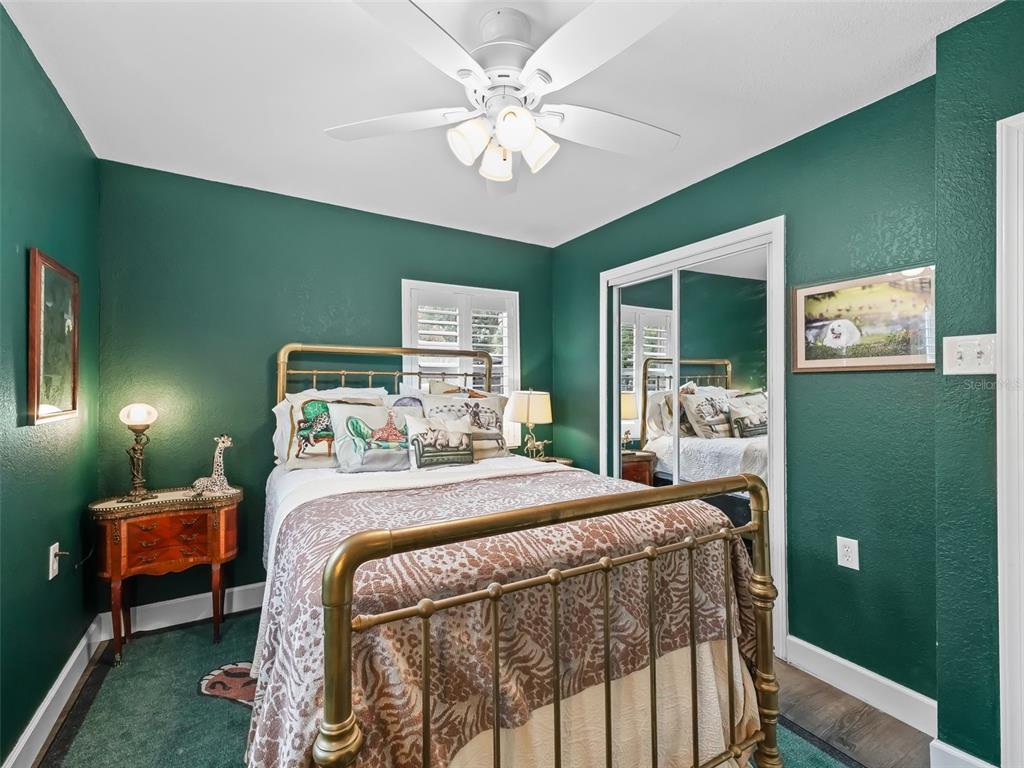 3505 Northeast 97th Street Road Anthony, FL 32617 - Photo 23 of 38 a bedroom with a bed and a chandelier
