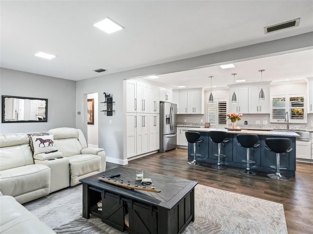 3505 Northeast 97th Street Road Anthony, FL 32617 - Photo 6 of 36 a living room with furniture and a dining table with kitchen view