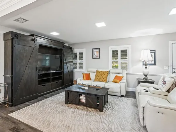 a kitchen with stainless steel appliances granite countertop a table chairs sink refrigerator and cabinets