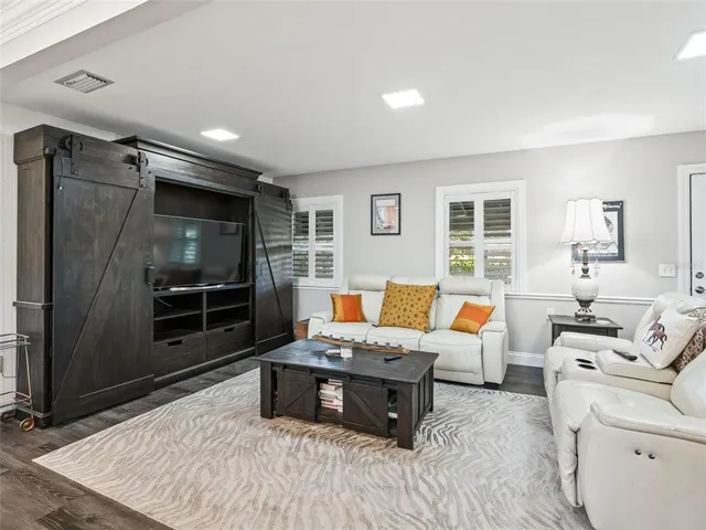 a kitchen with kitchen island granite countertop a sink and a refrigerator