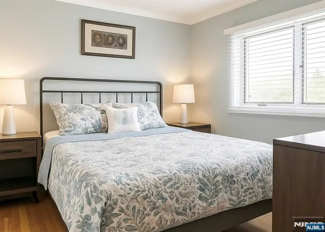 a large bed sitting in a bedroom next to a window