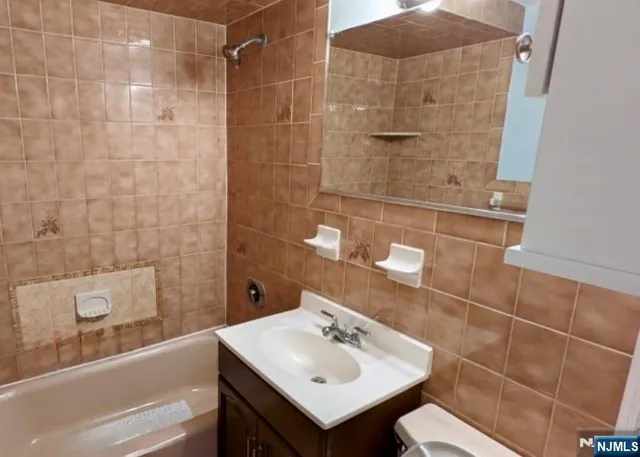 a bathroom with a sink mirror and shower