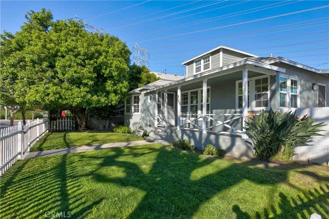 a front view of a house with a yard table and chairs