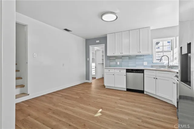 a kitchen with stainless steel appliances a white stove top oven cabinets and a refrigerator