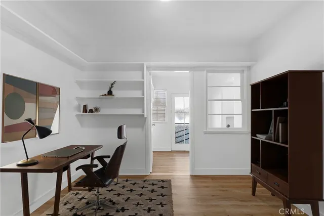 a view of a workspace with furniture and wooden floor