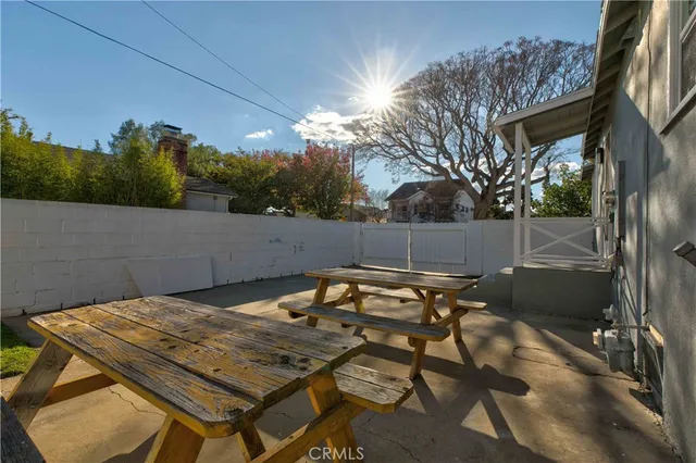 a backyard of a house with table and chairs
