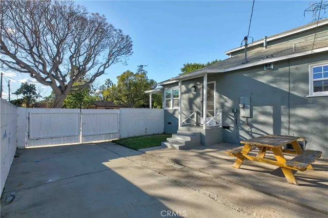 a view of a backyard with wooden fence