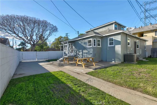 a view of a house with backyard and sitting area