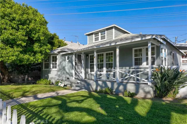 a front view of a house with yard and green space