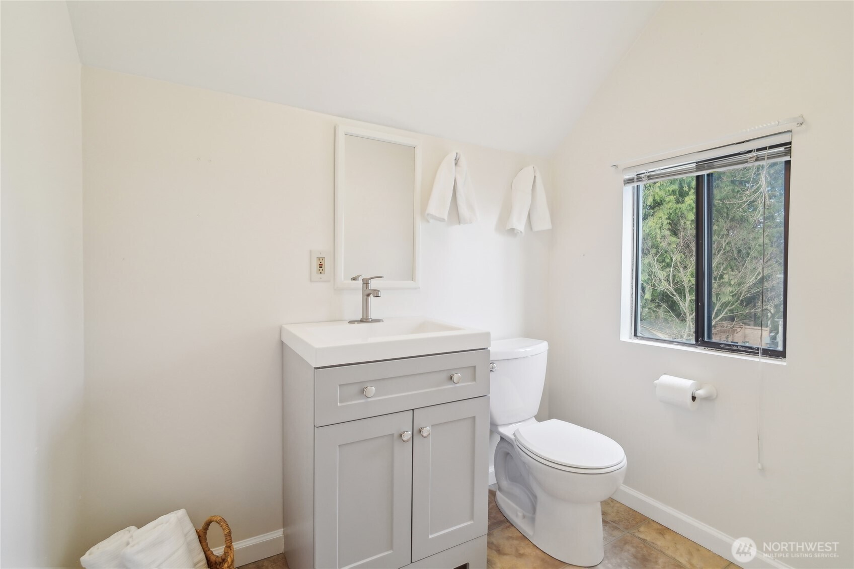 1420 North 50th Street Seattle, WA 98103 - Photo 19 of 32 a bathroom with a toilet a sink a mirror and a window