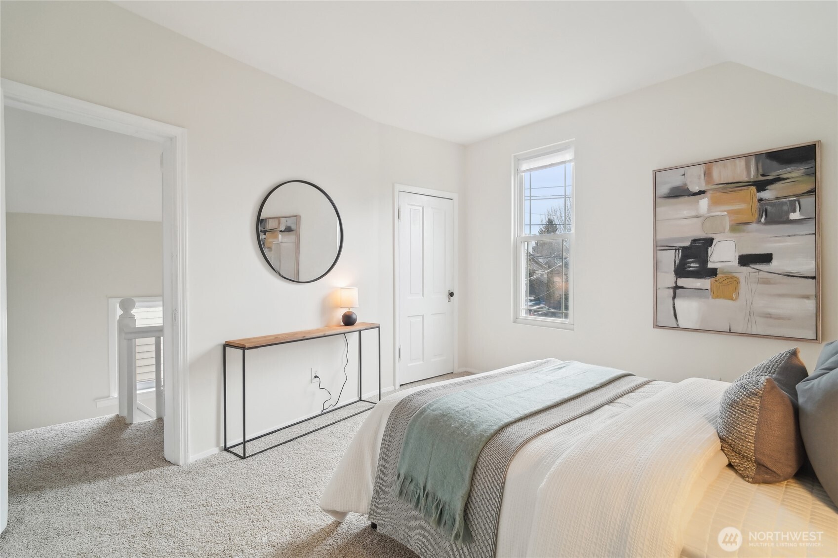 1420 North 50th Street Seattle, WA 98103 - Photo 22 of 32 a bedroom with a bed mirror and a window