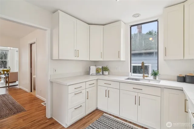 a kitchen with white cabinets and white appliances
