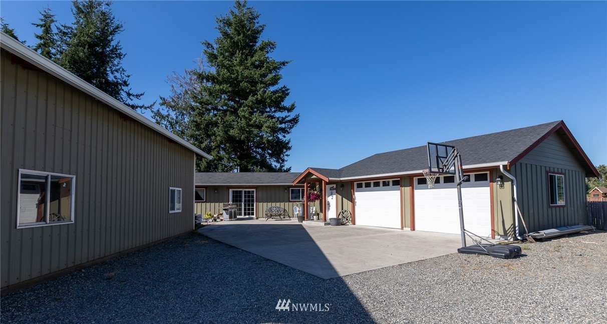 7122 Enterprise Road Ferndale, WA 98248 - Photo 1 of 33 a front view of a house with a yard and garage