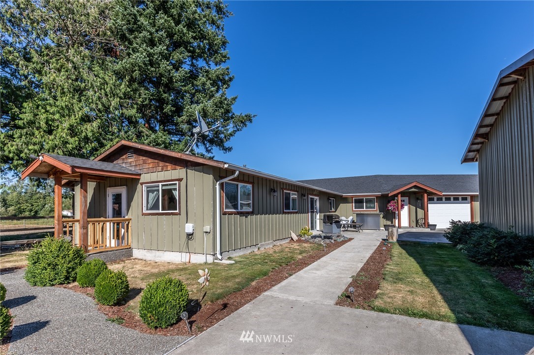 7122 Enterprise Road Ferndale, WA 98248 - Photo 2 of 33 a front view of a house with a yard and garage