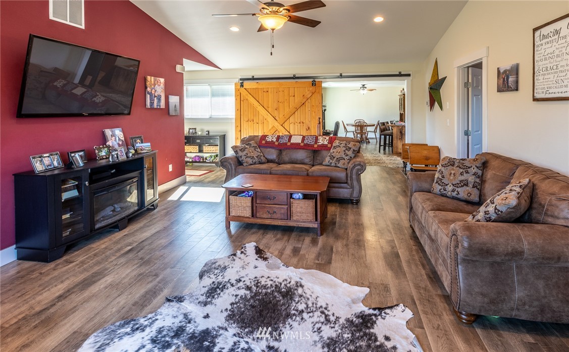 7122 Enterprise Road Ferndale, WA 98248 - Photo 11 of 33 a living room with furniture flat screen tv and wooden floor