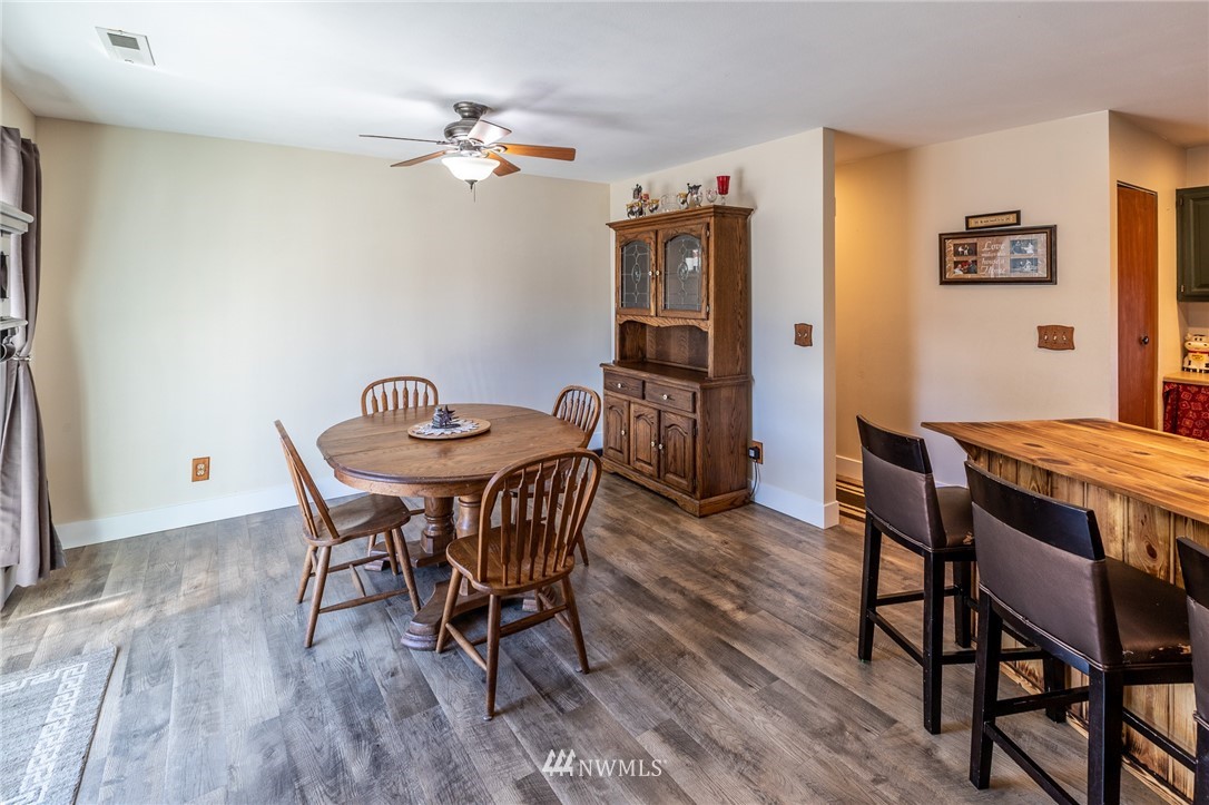 7122 Enterprise Road Ferndale, WA 98248 - Photo 16 of 33 a view of a dining room with furniture and wooden floor