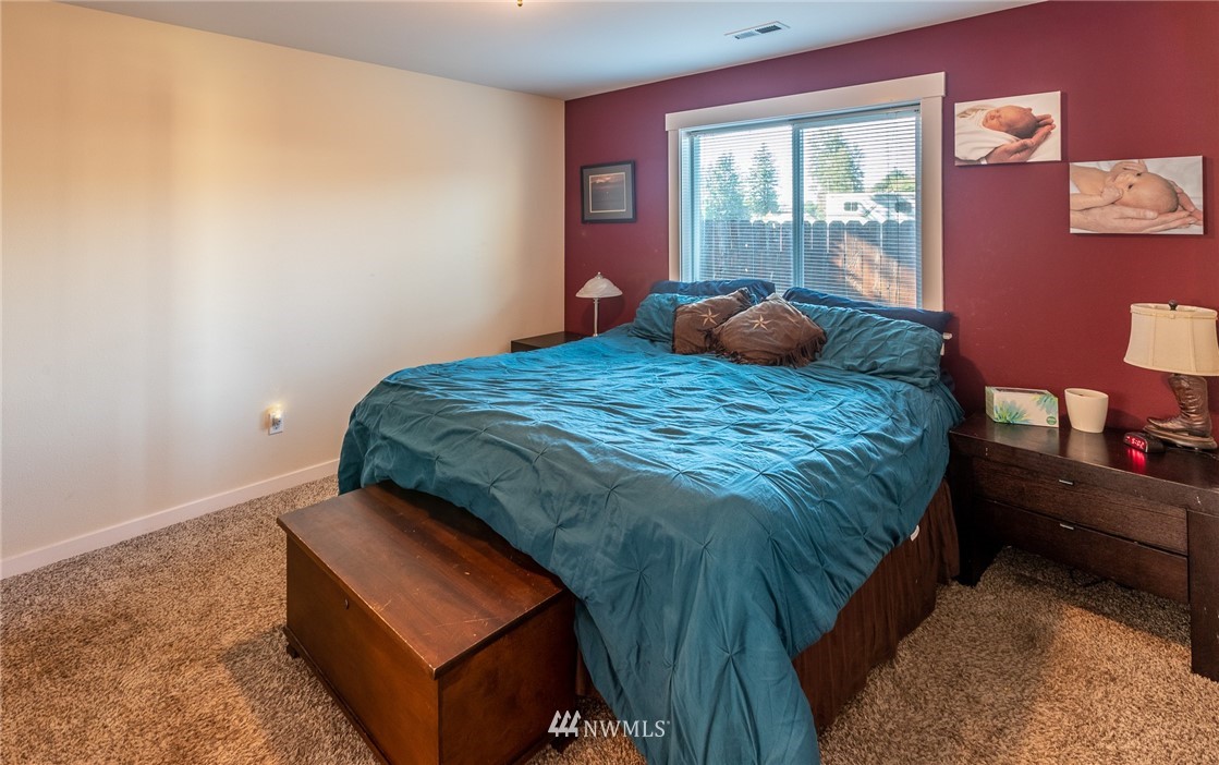 7122 Enterprise Road Ferndale, WA 98248 - Photo 19 of 33 a bedroom with a bed and wooden floor