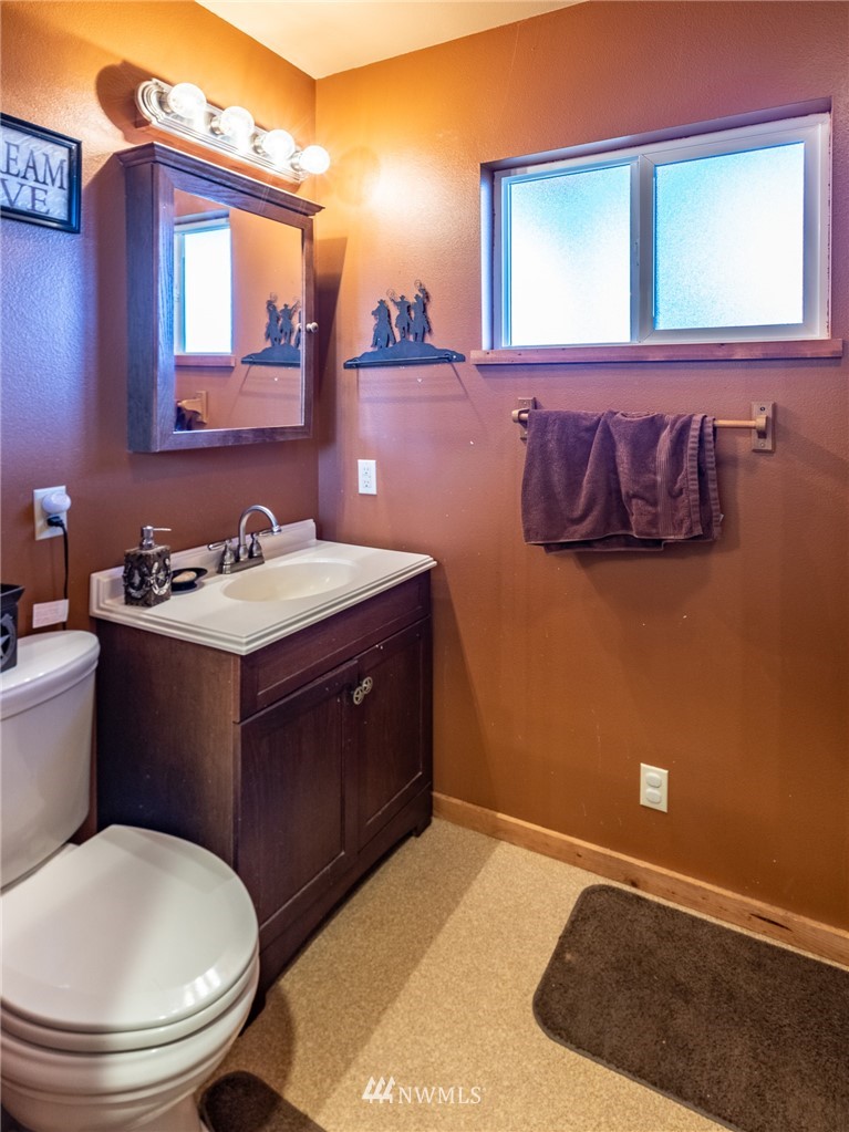 7122 Enterprise Road Ferndale, WA 98248 - Photo 20 of 33 a bathroom with a sink a toilet and mirror