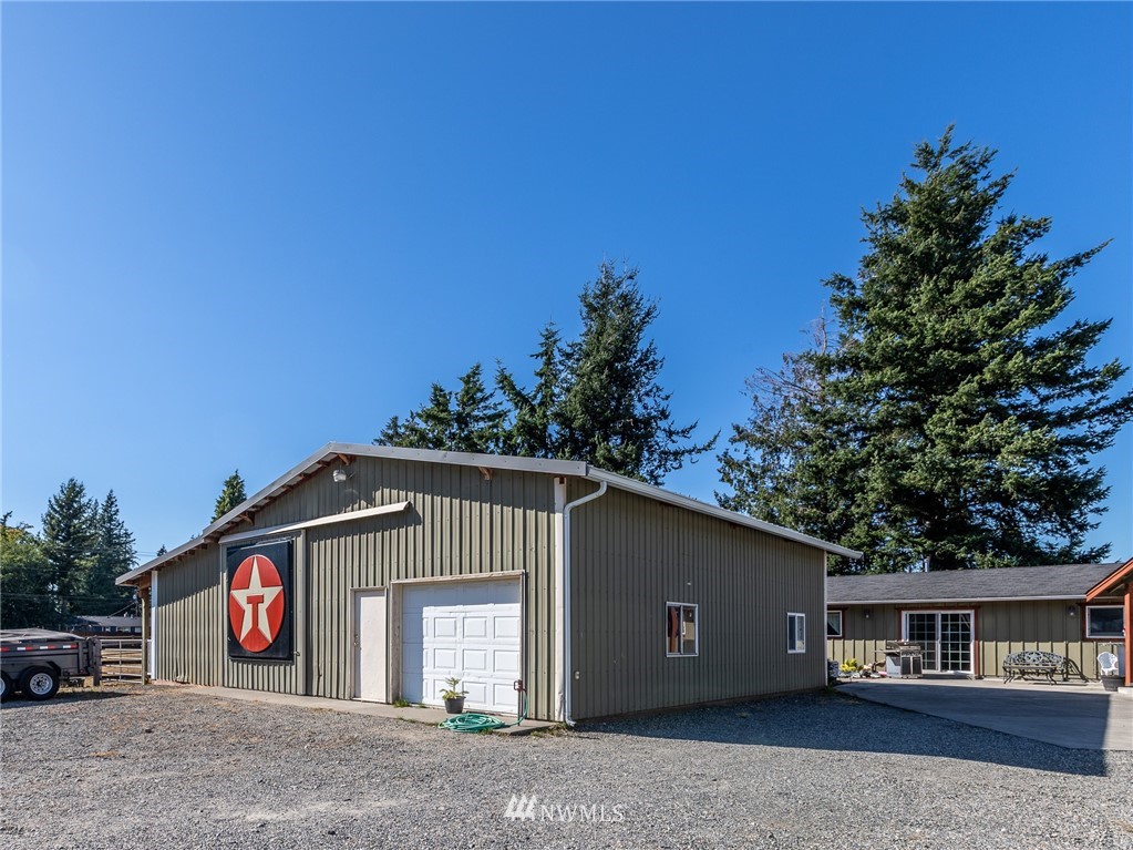 7122 Enterprise Road Ferndale, WA 98248 - Photo 28 of 33 a front view of a house with a yard and garage
