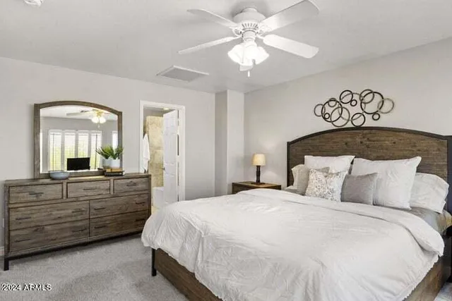 a bedroom with a large bed and a mirror