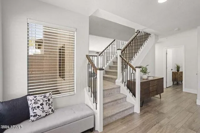 a view of a livingroom with wooden floor and a potted plant