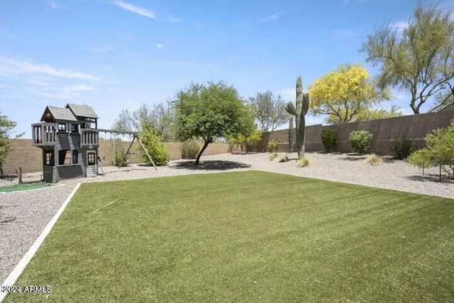a view of a house with swimming pool and sitting area