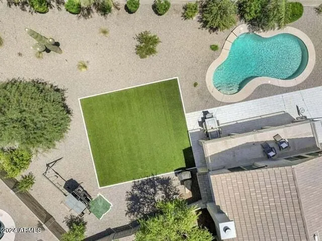an aerial view of residential houses and trees in the background