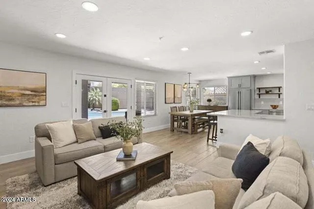 a living room with furniture and view of kitchen