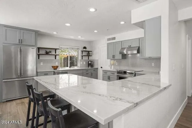 a large kitchen with kitchen island a table and chairs