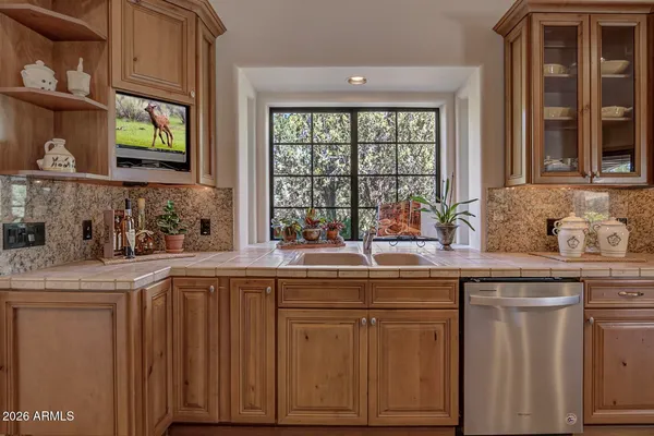 a kitchen with cabinets and window