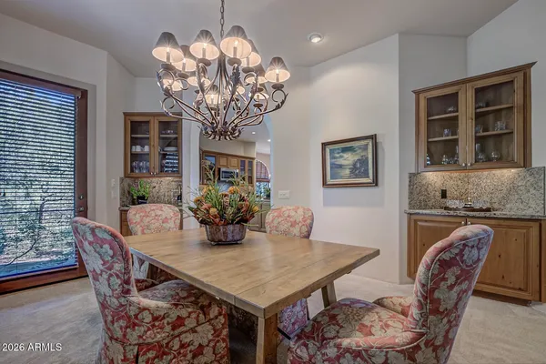 a view of a dining room with furniture wooden floor and chandelier