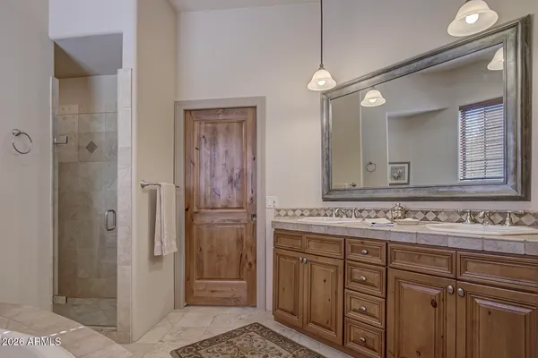 a bathroom with a sink vanity and a mirror