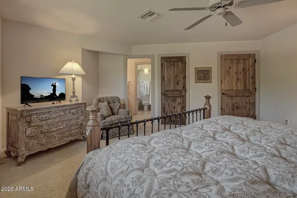 a bedroom with a bed and a chandelier