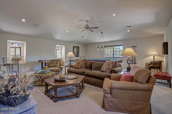 a living room with furniture potted plant and a window