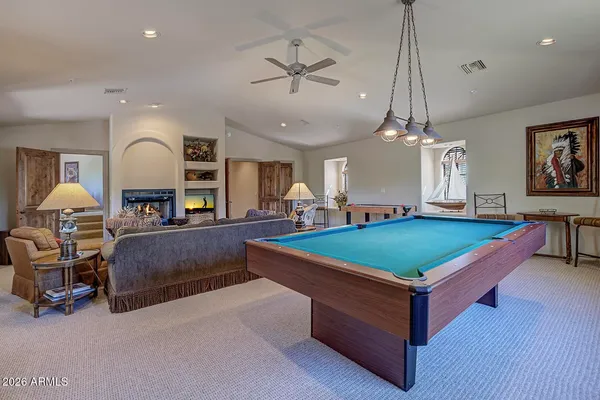 a room with pool table and windows