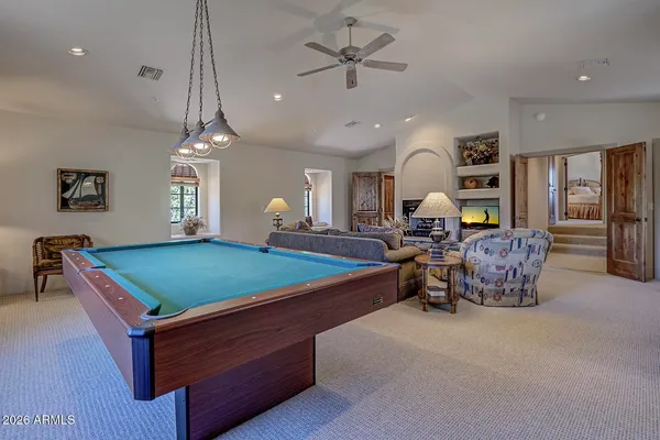 a room with pool table and windows