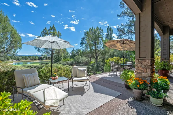 a patio with a patio a table and chairs under an umbrella