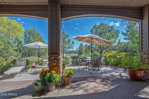 a view of a patio with chairs and potted plants