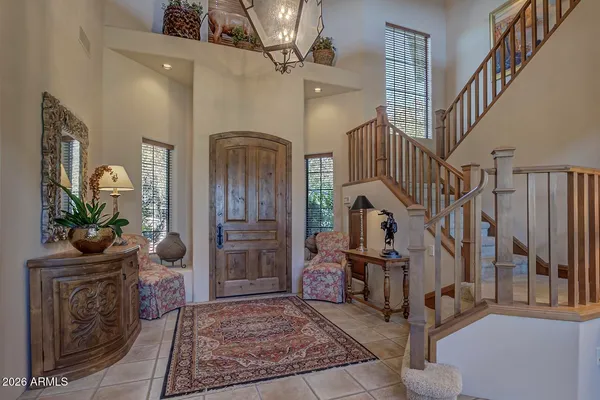 a living room with lots of furniture and stairs