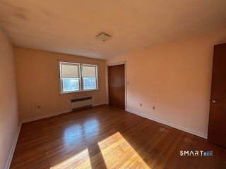 11 Edgewood Road Portland, CT 06480 - Photo 8 of 17 an empty room with wooden floor and windows